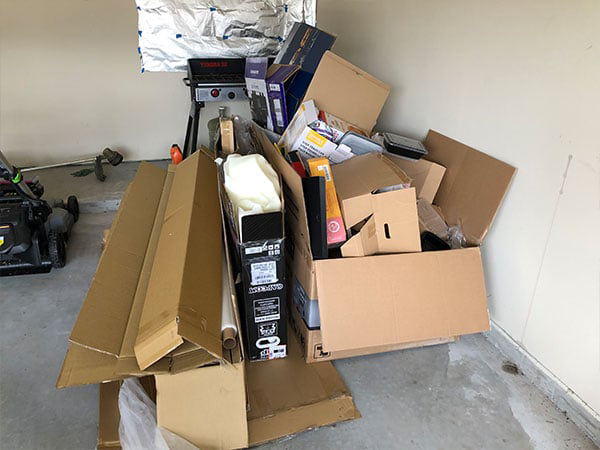 pile of cardboard and empty boxes in a garage