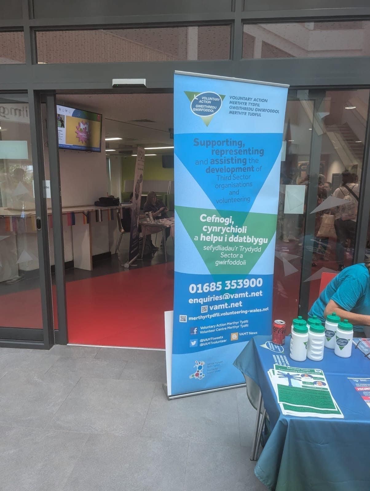 A table with a sign in front of a building