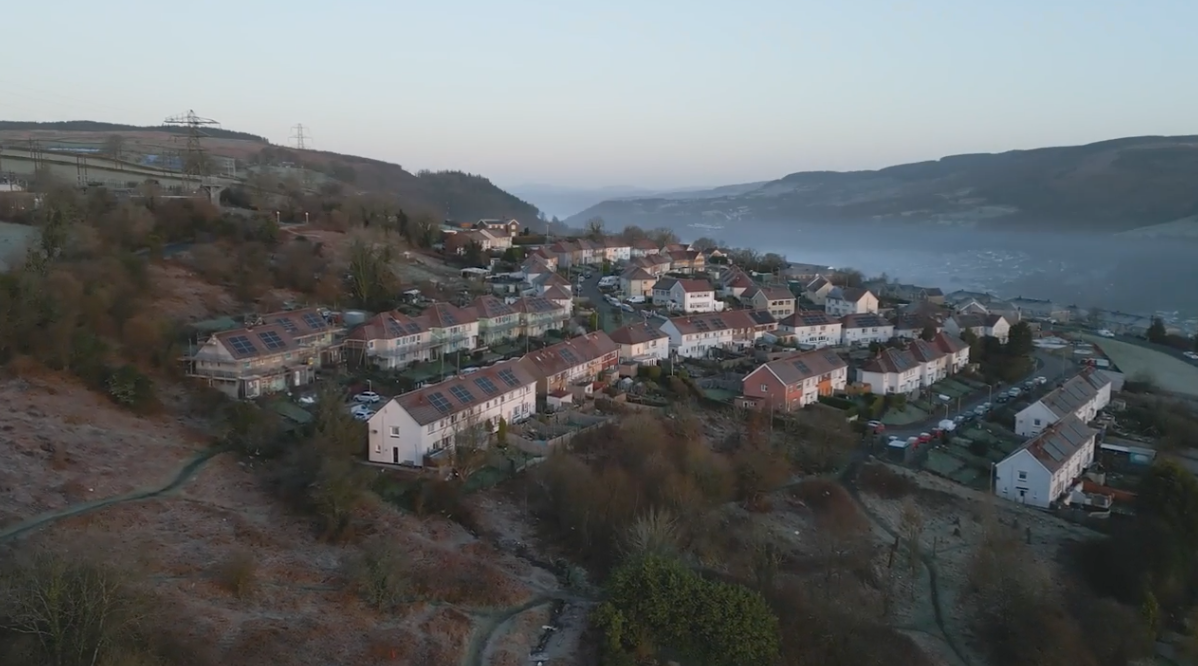 An aerial view of a small town on top of a hill.