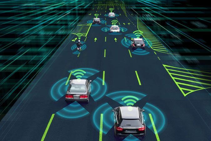 Autonomous cars driving on a glowing digital highway with sensor rings and lane markers