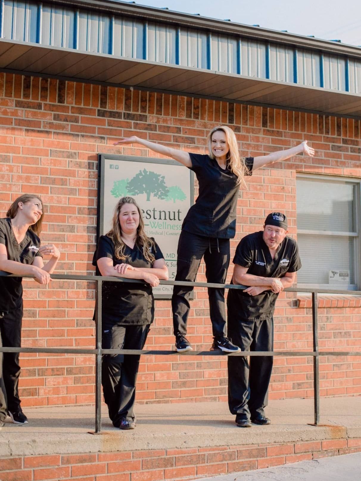 a group of people standing in front of a chestnut medspa 