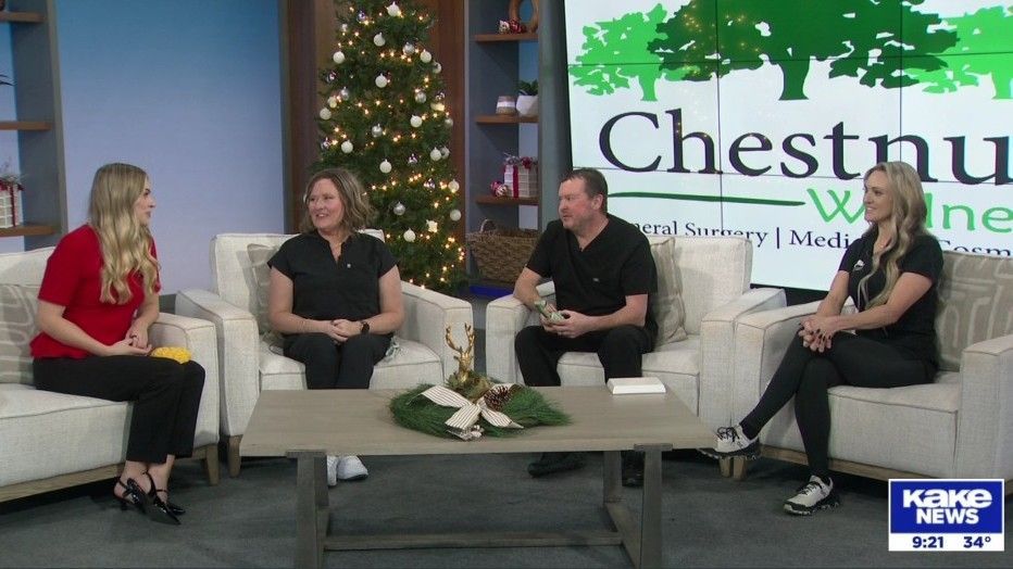 Four people on the KAKE TV studio set, talking. Chestnut Wellness sign visible.