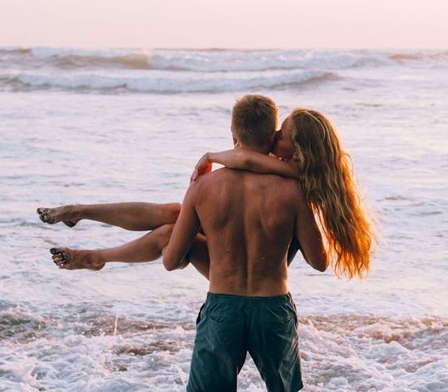 a man and a woman are hugging each other on a bed