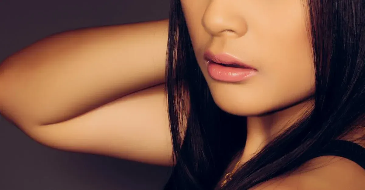 a close up of a woman 's face with long black hair .