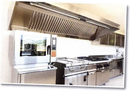 A kitchen with stainless steel appliances and a microwave oven