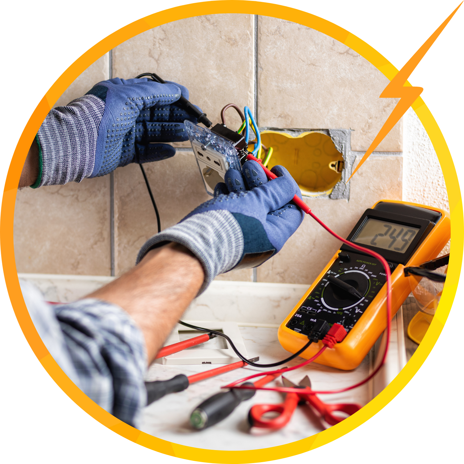 Electrician testing wires in a wall outlet with a multimeter, wearing gloves.