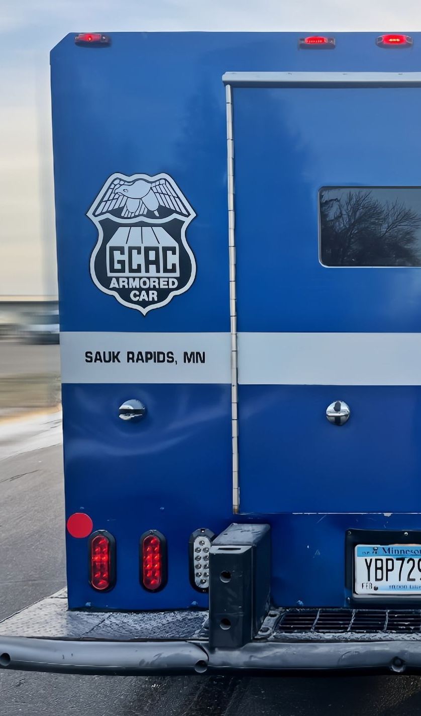 A white truck is driving down a city street.