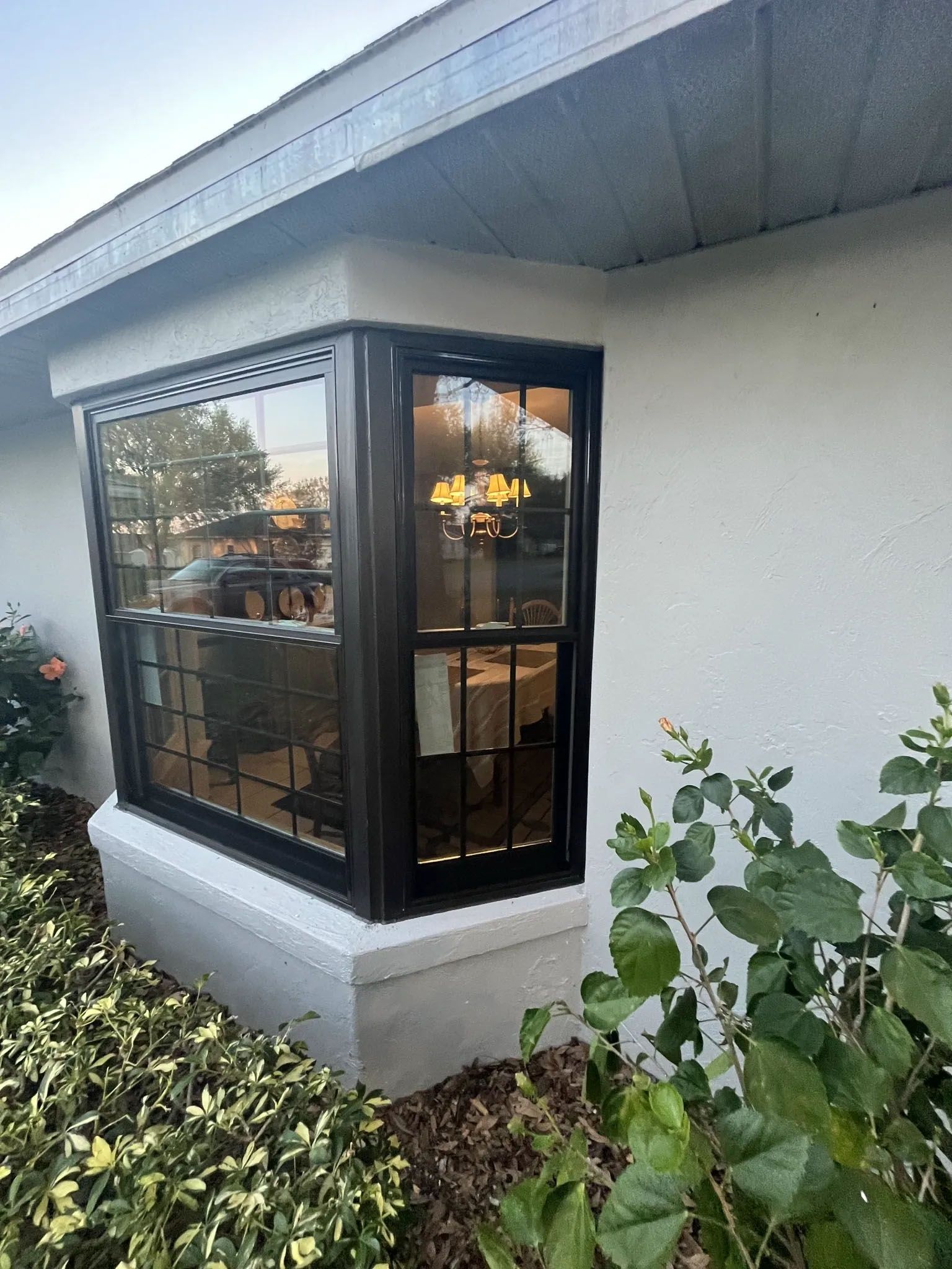 A white house with a black window and a black door.