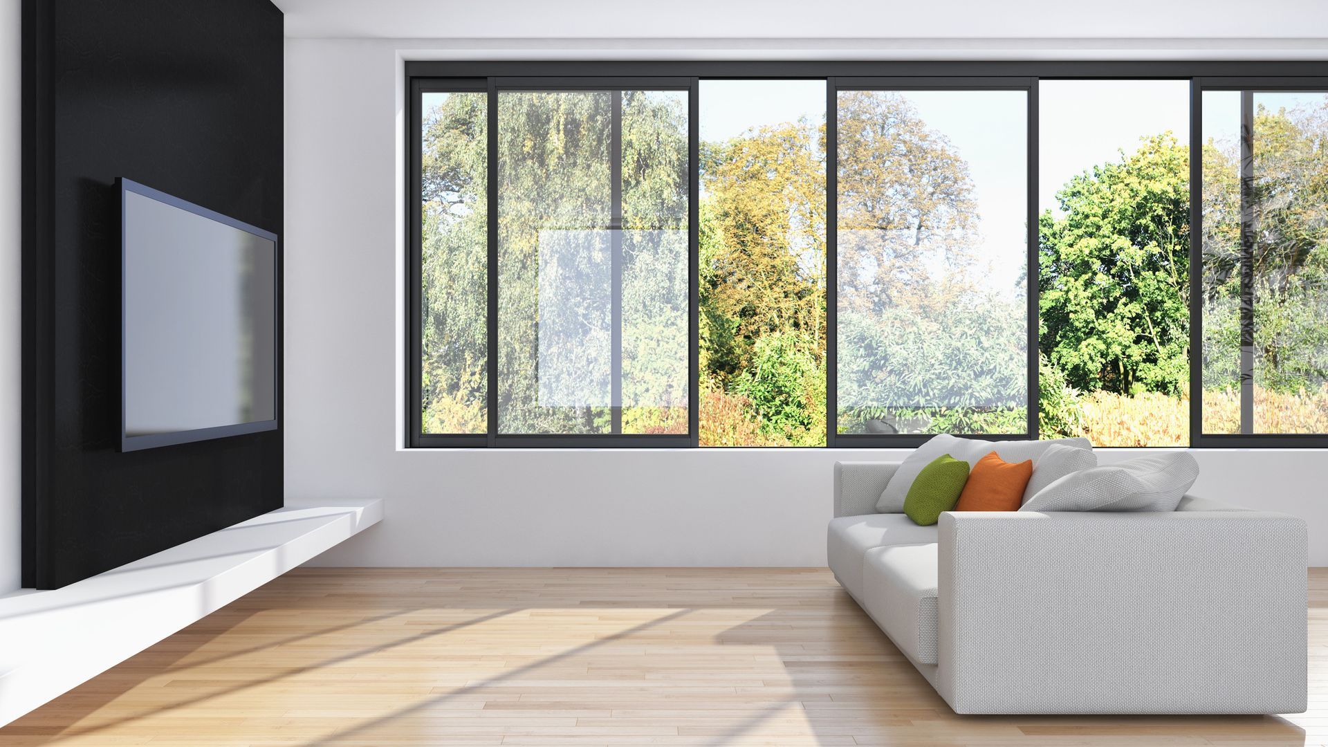 A living room with a couch , television , and lots of windows.