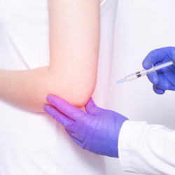 a person is getting an Corticosteroid Injection in their elbow