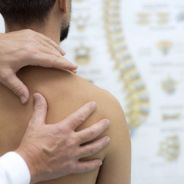 a chiropractor looking into a patient who may need spinal traction as a treatment