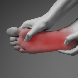 a person is holding their foot in pain with Neuropathy 