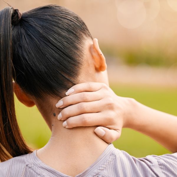 A women holding her neck due to neck pain