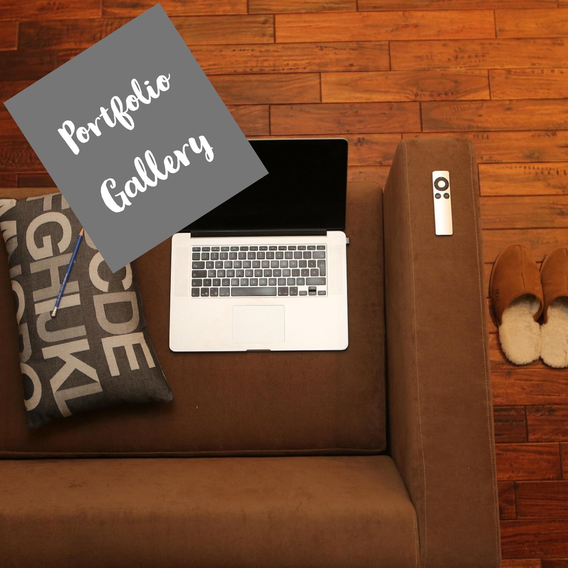 A laptop sits on a couch next to a portfolio gallery sign