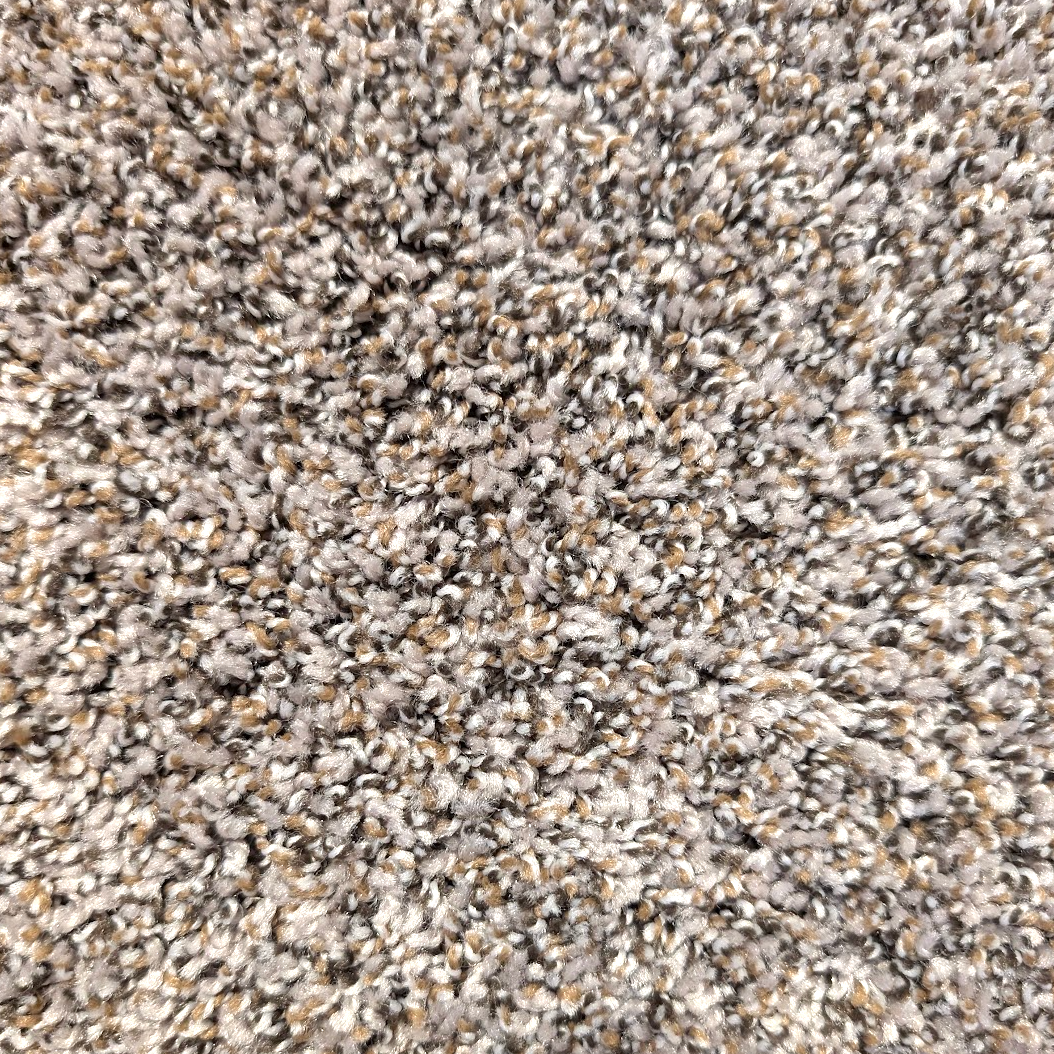 Close-up of speckled carpet in shades of gray, tan, and black.