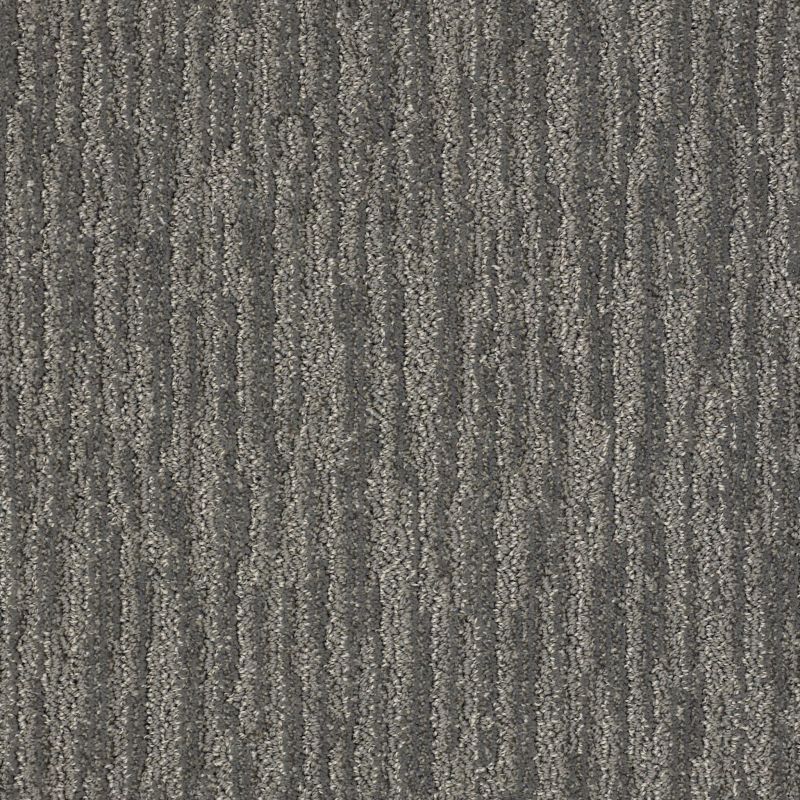 A close up of a gray carpet with a striped pattern.