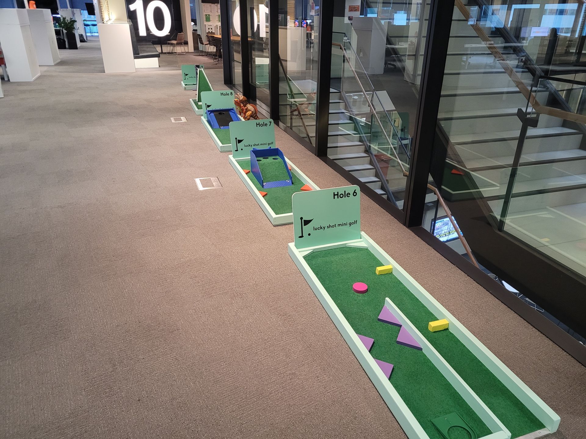 Mortal Kombat arcade cabinet playing a video game. Gray cabinet with buttons, screen shows a character with a gun.