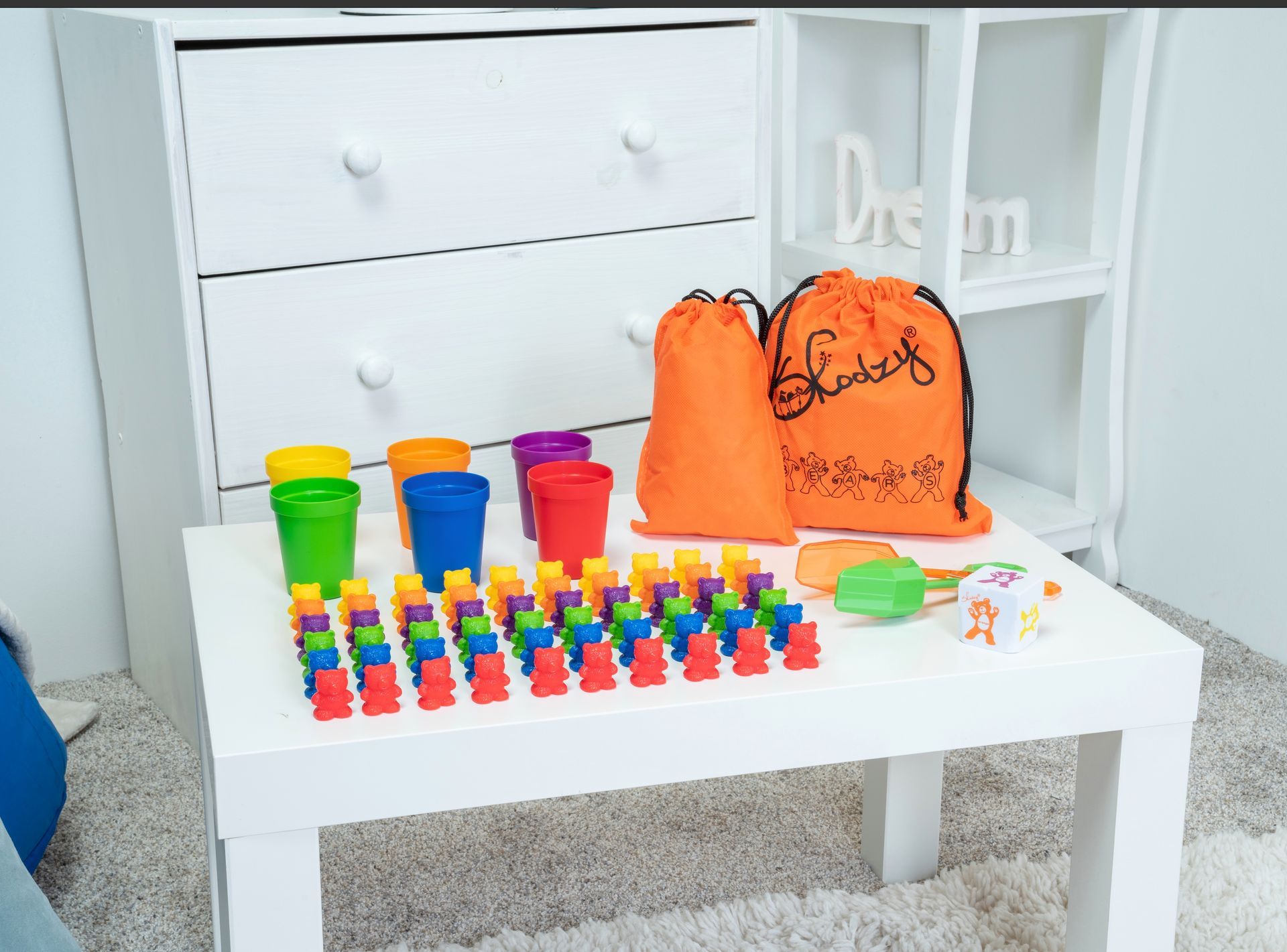 A white table with a bunch of colorful toys on it.