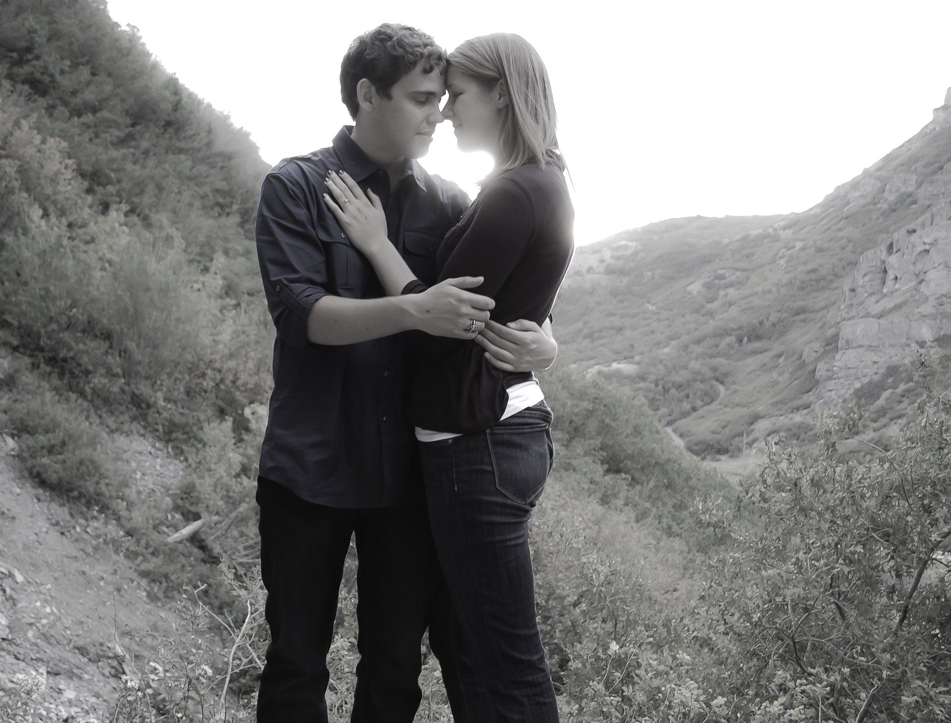 A black and white photo of a man and woman hugging