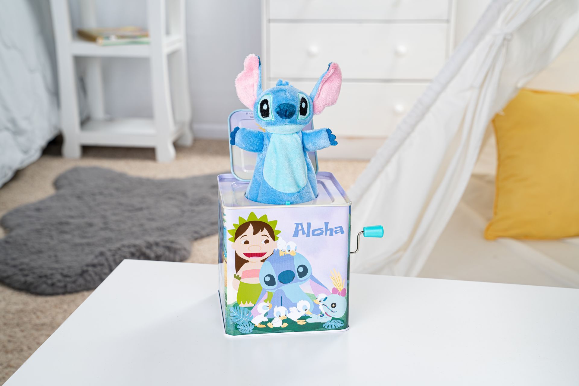 A lilo and stitch jack in the box is sitting on a table.