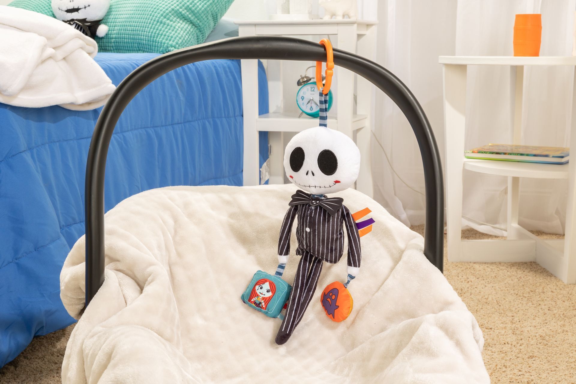 A stuffed skeleton is sitting in a car seat.