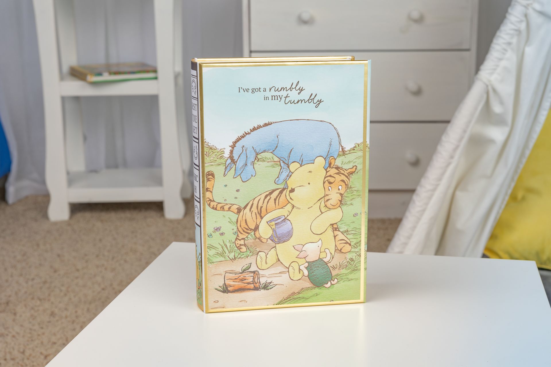 A winnie the pooh book is sitting on a white table.