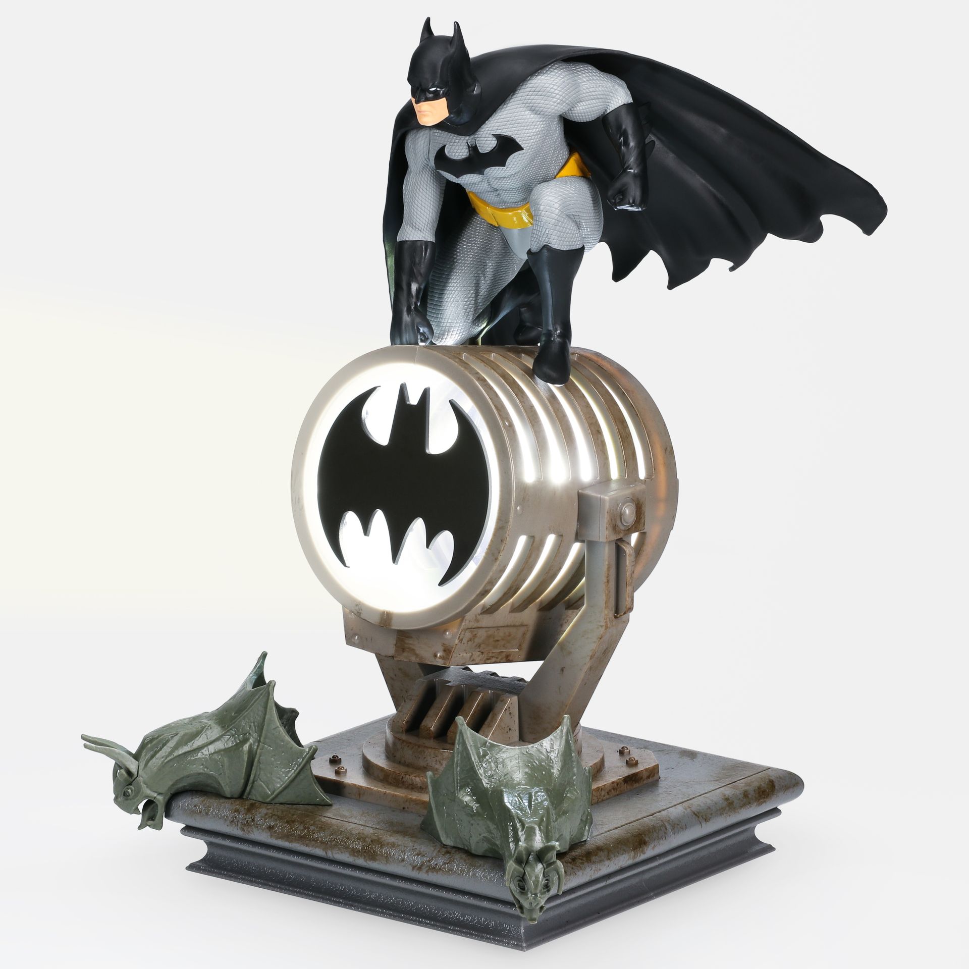 A statue of batman standing on top of a barrel