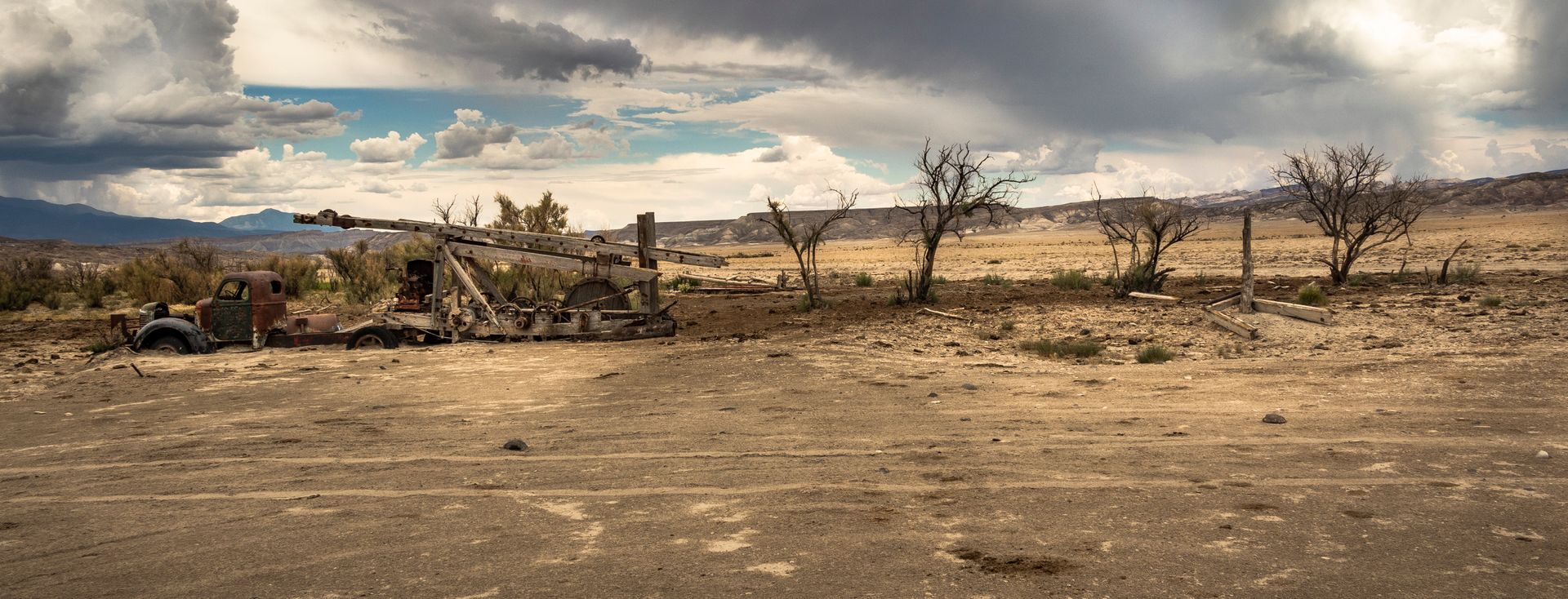 A jeep is parked in the middle of a desert.