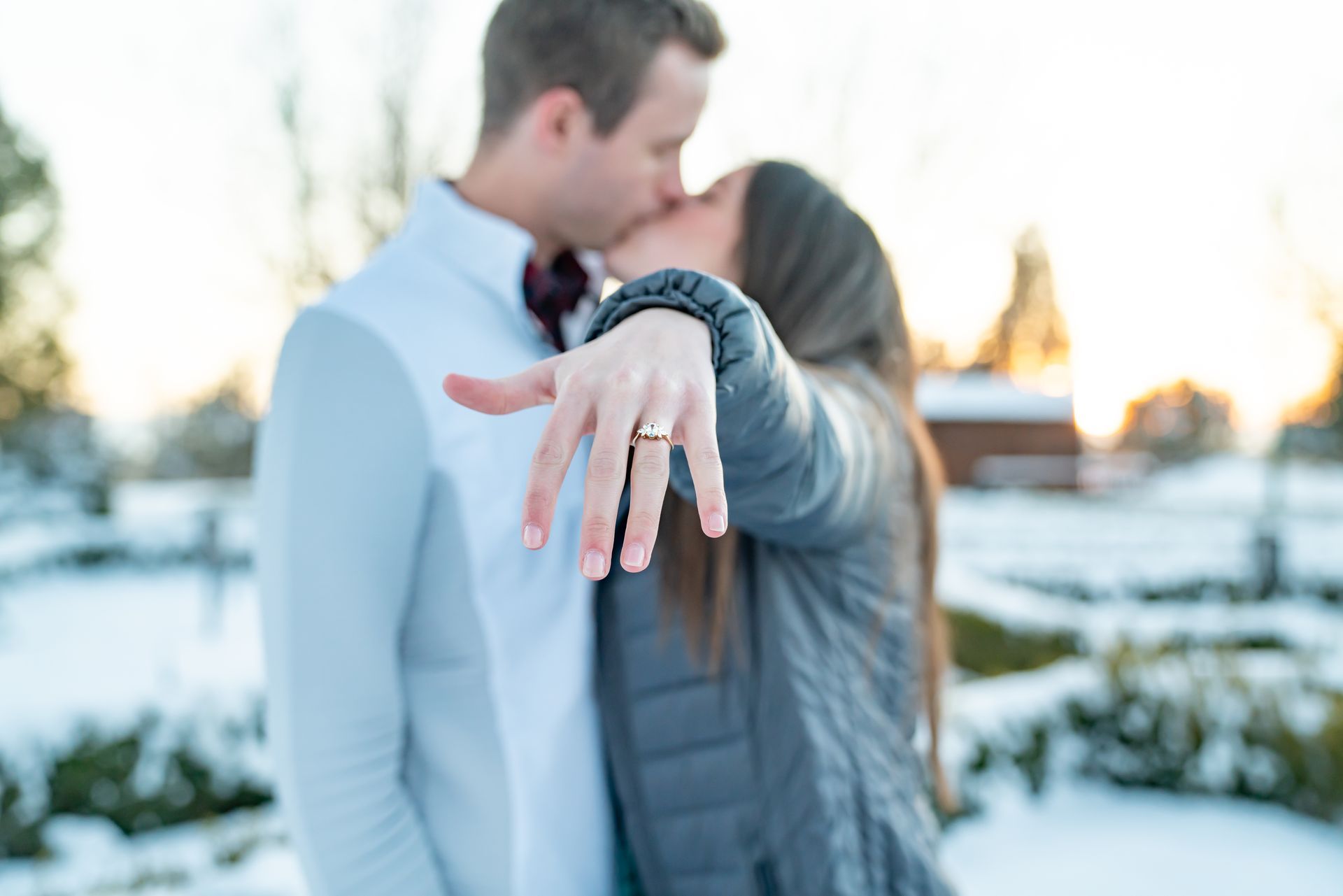 A man is putting an engagement ring on a woman 's finger.