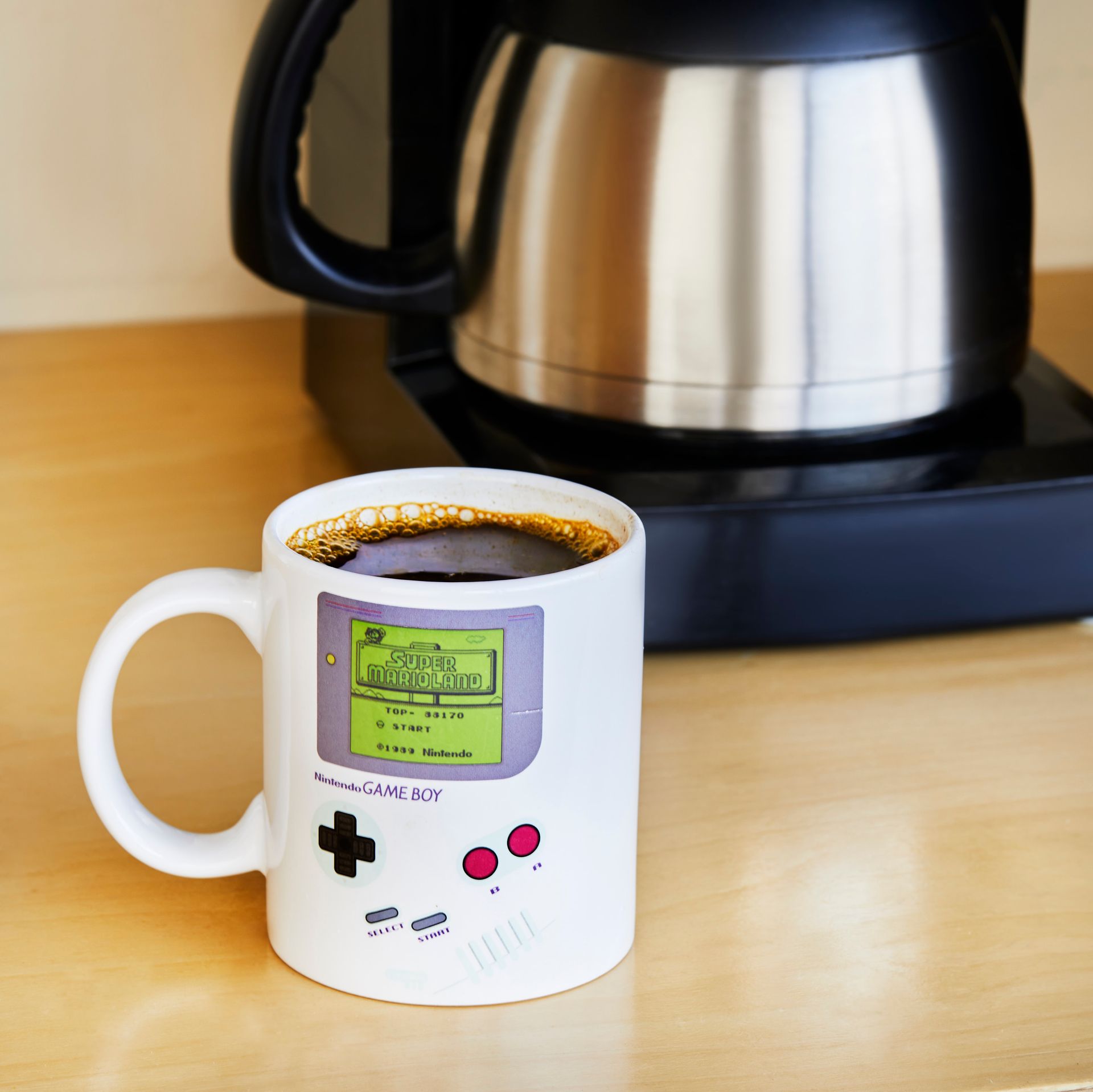 A coffee mug with a game boy on it