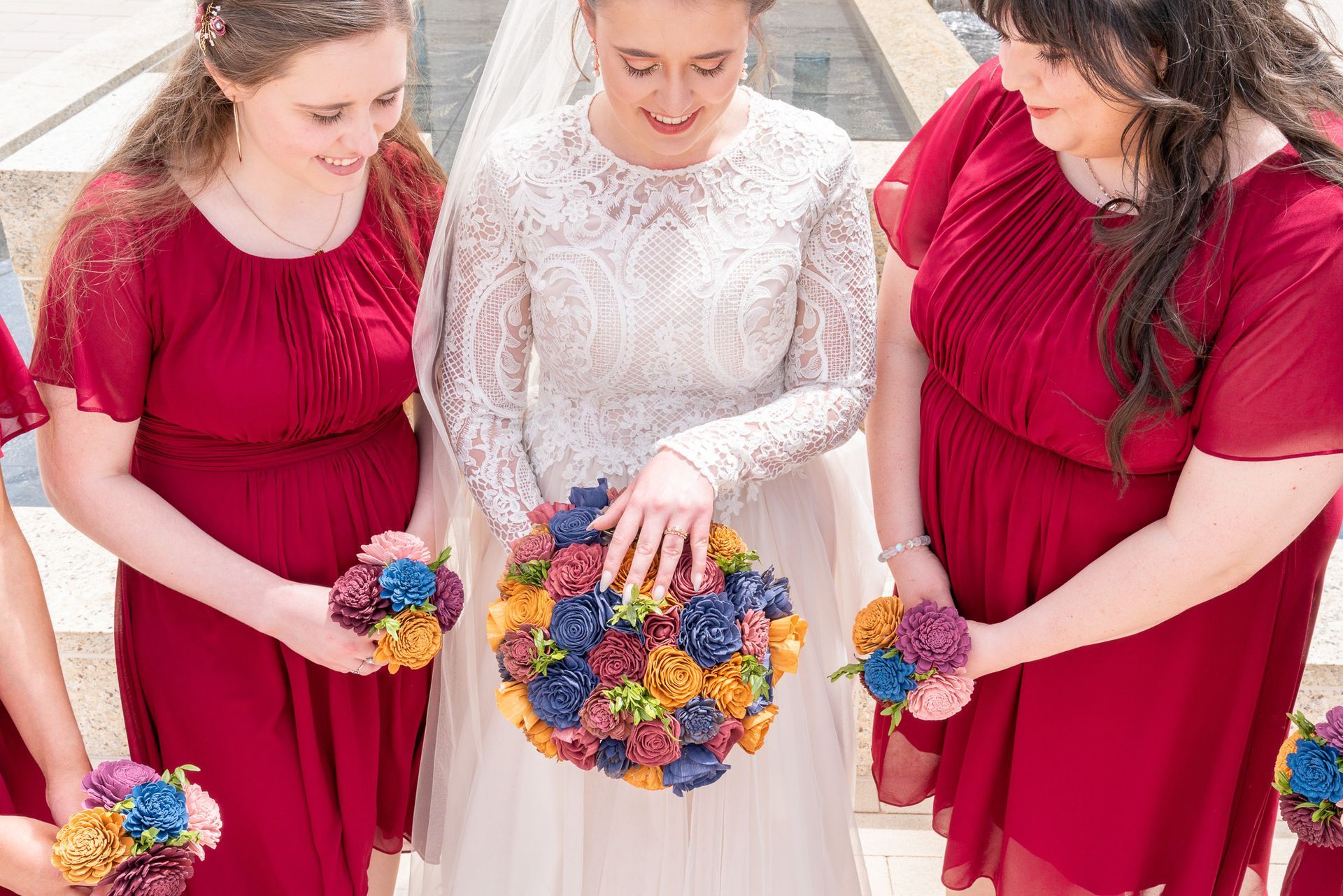 A bride and her bridesmaids are holding a bouquet of flowers.