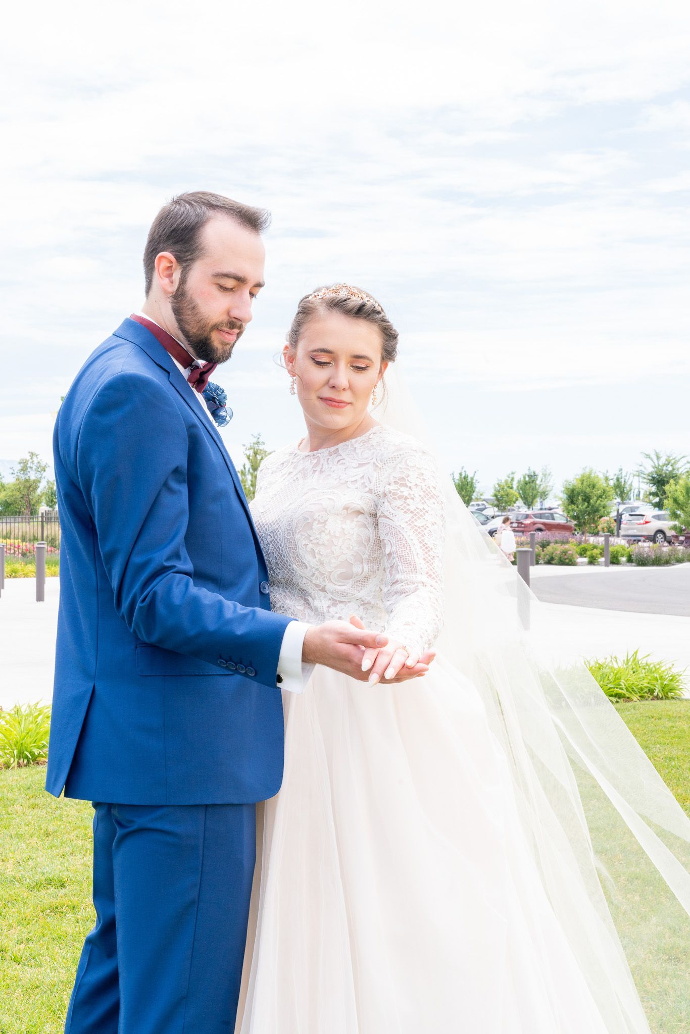 A bride and groom are posing for a picture on their wedding day.