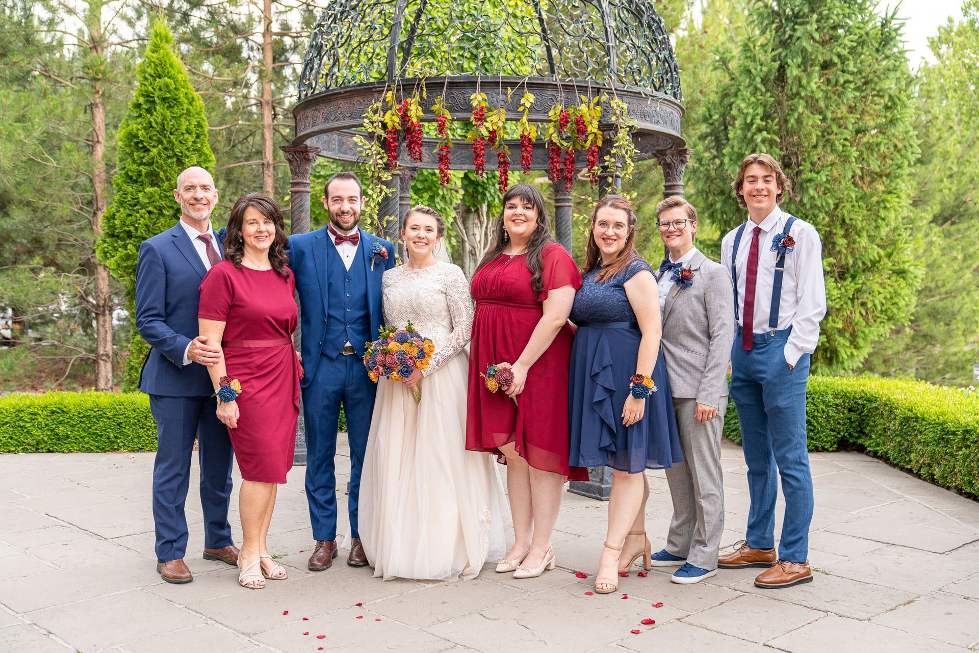 A group of people standing next to each other in front of a gazebo.