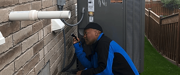 A man is looking through a magnifying glass at a brick wall.
