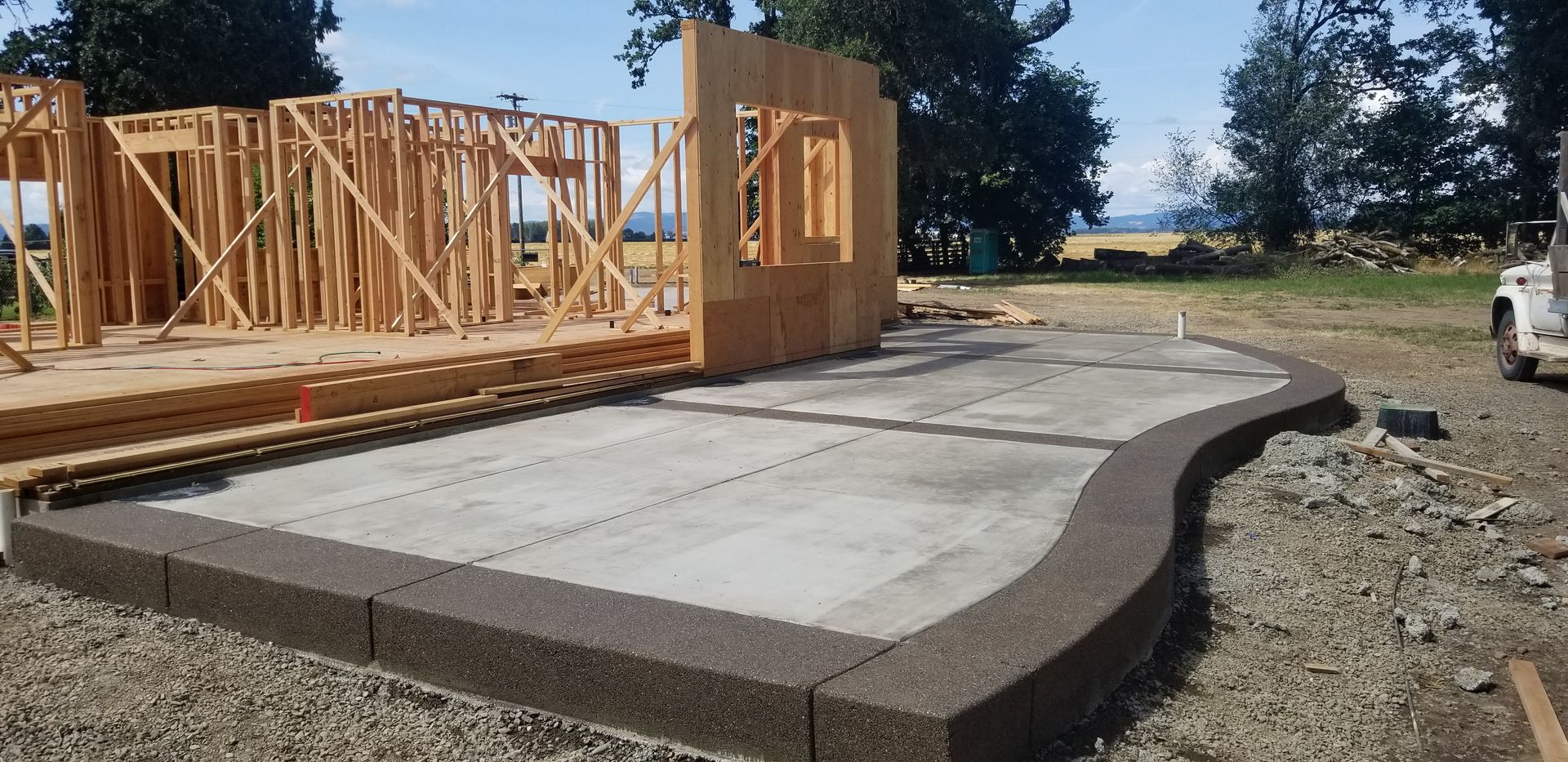 A house is being built in the middle of a dirt field.