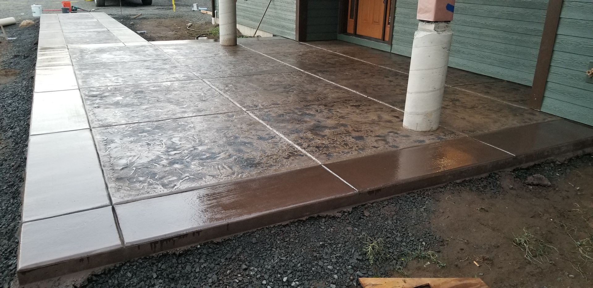 A concrete walkway is being built in front of a building.