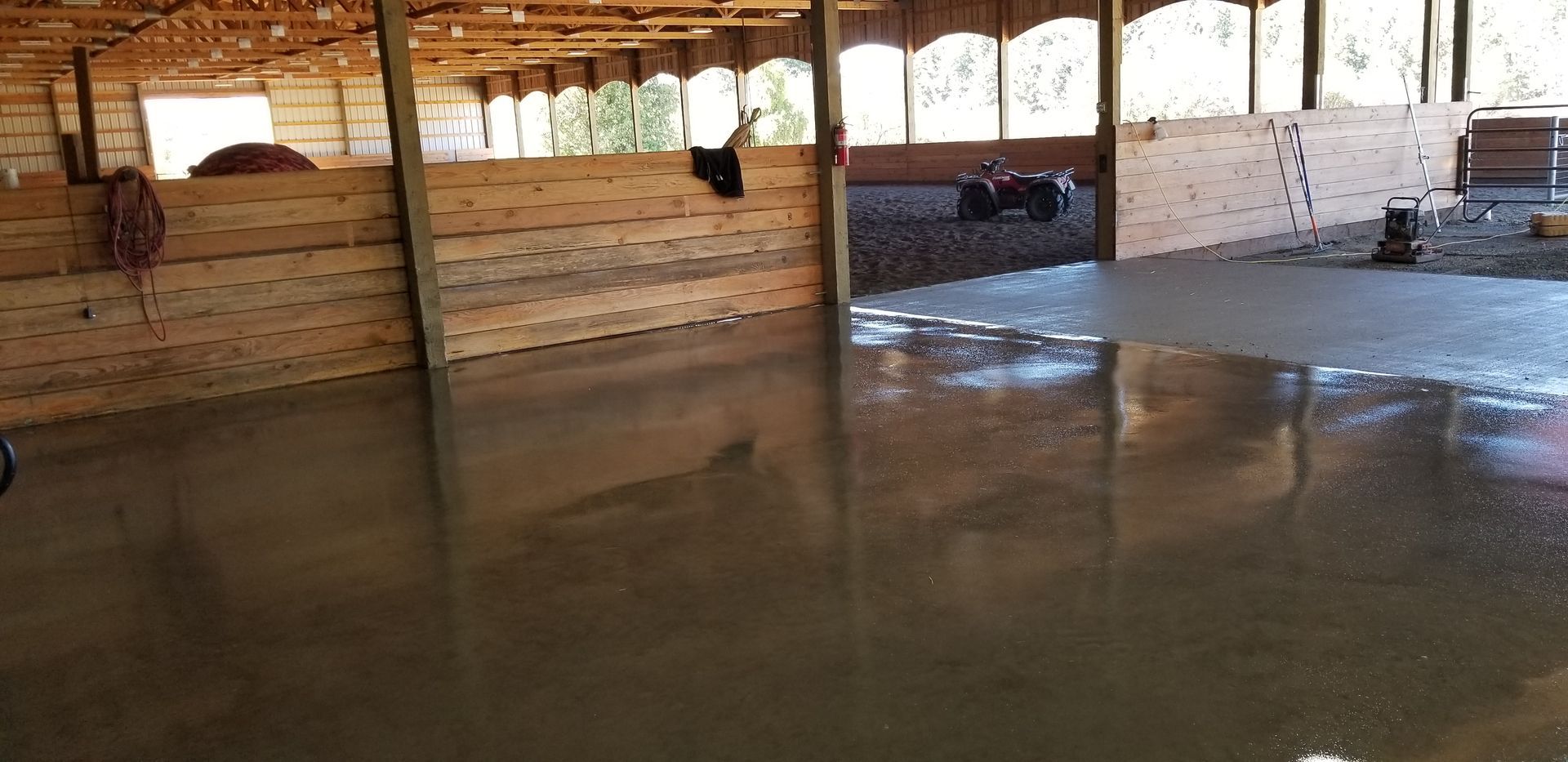 A large room with a concrete floor and wooden walls