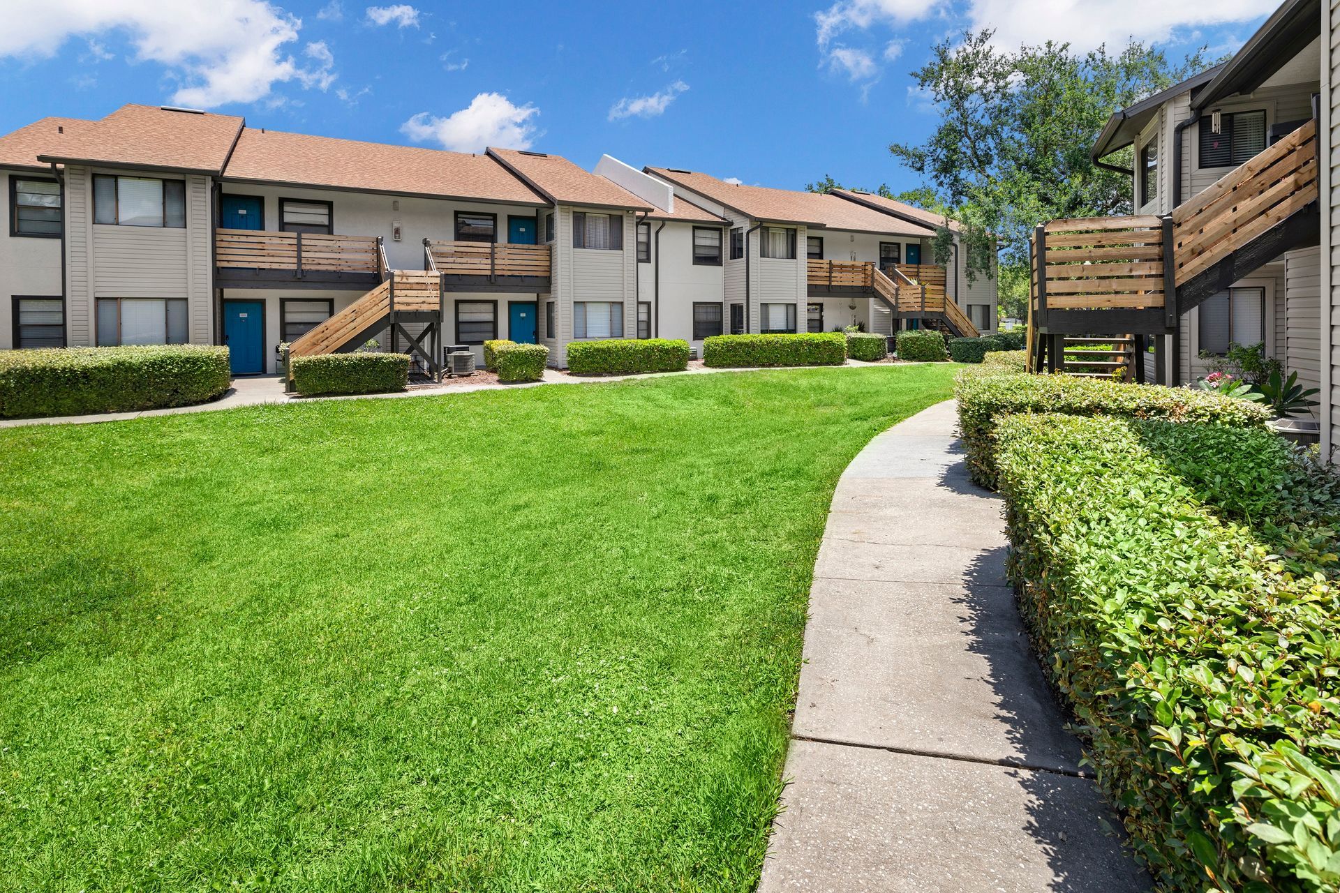A bedroom with a large bed and a ceiling fan.