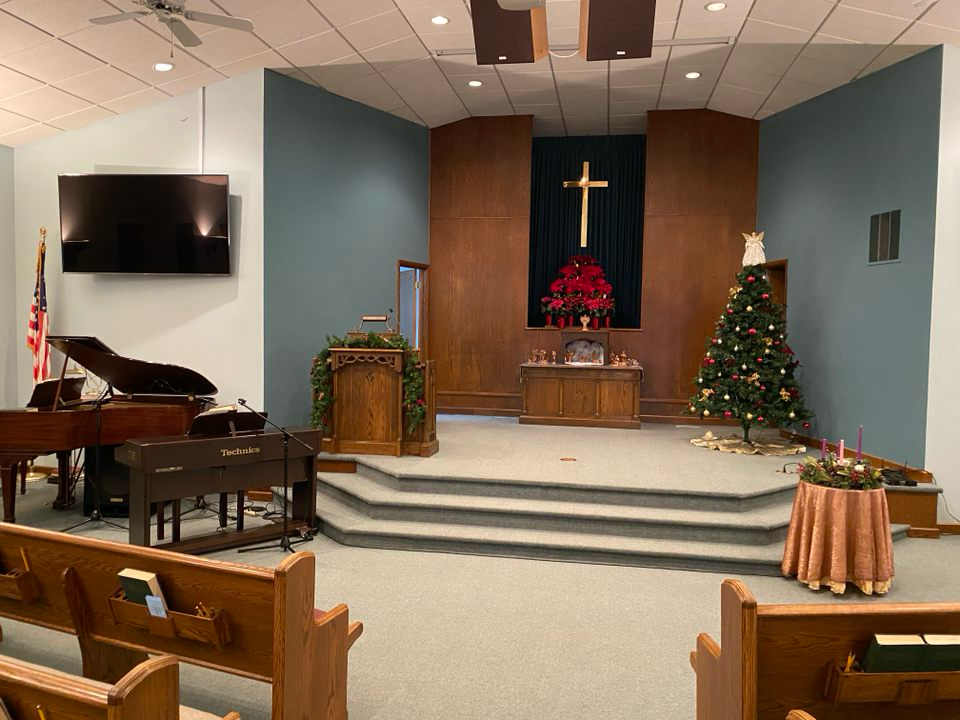 there is a christmas tree in the middle of the church .