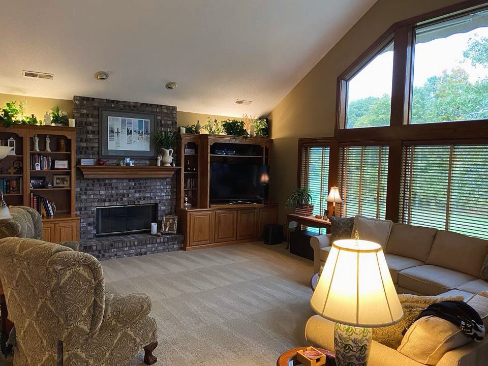 a living room filled with furniture and a fireplace .