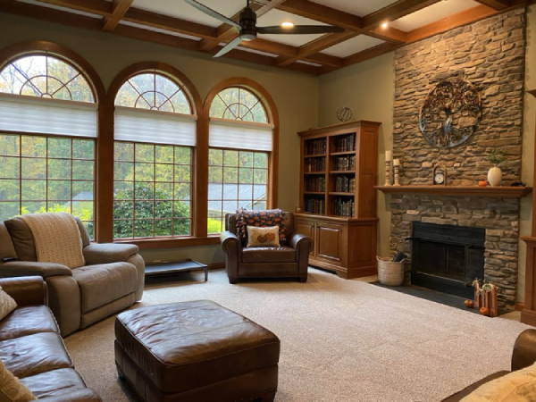 a living room with a fireplace and lots of windows