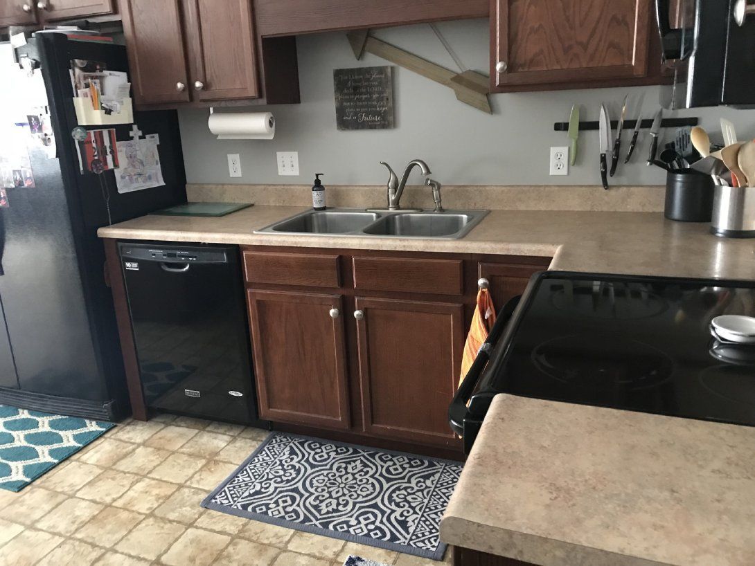 a kitchen with a sink stove and refrigerator