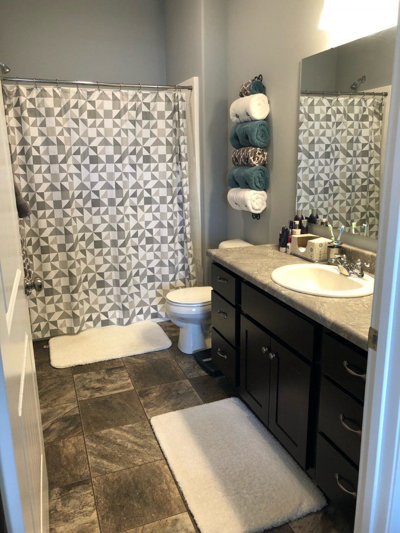 a bathroom with a toilet , sink , and shower curtain .