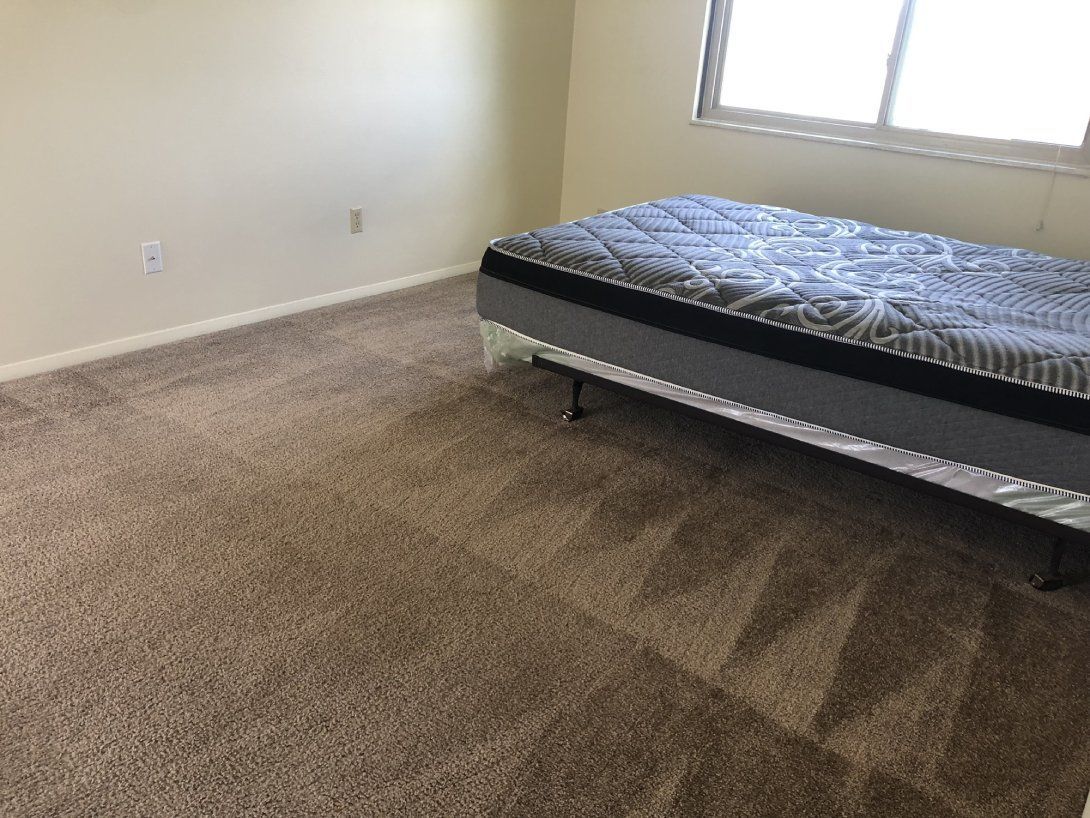 a bedroom with a mattress and a window .