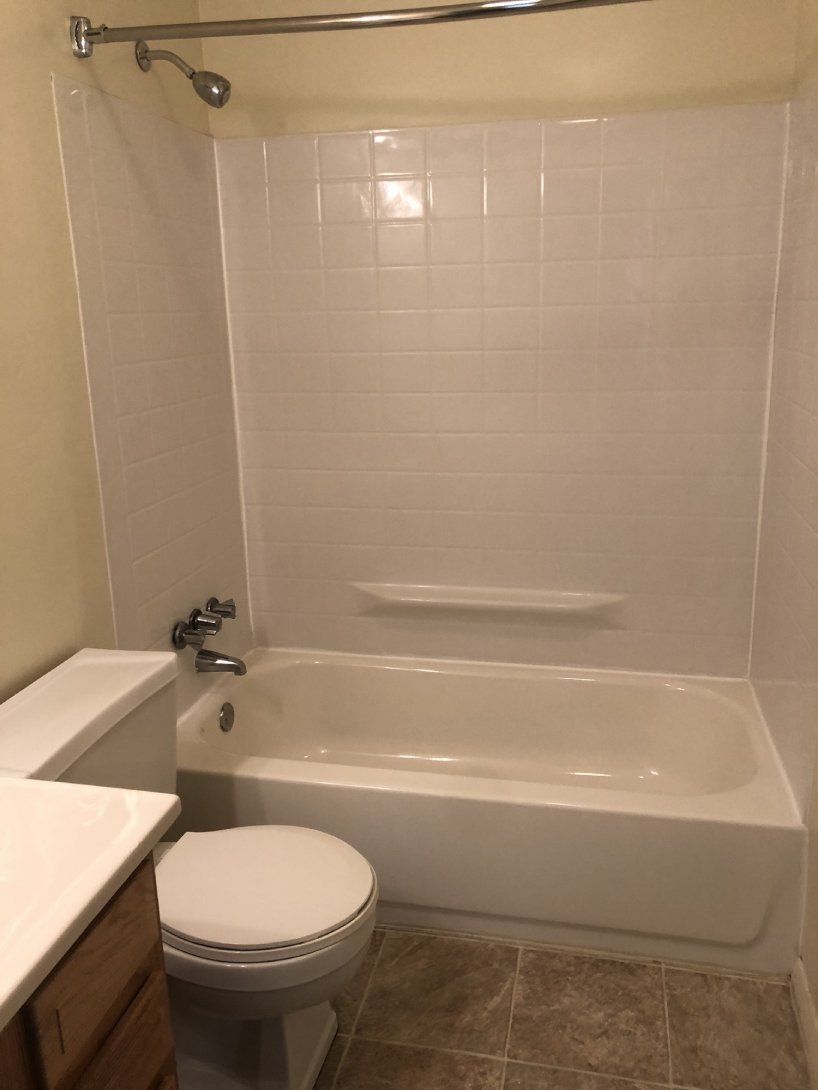 a bathroom with a toilet a bathtub and a shower