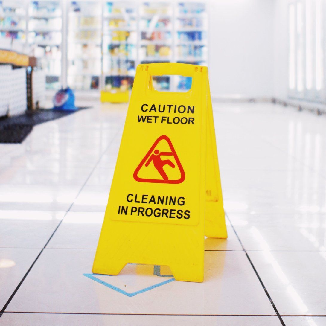 a yellow sign that says caution wet floor cleaning in progress