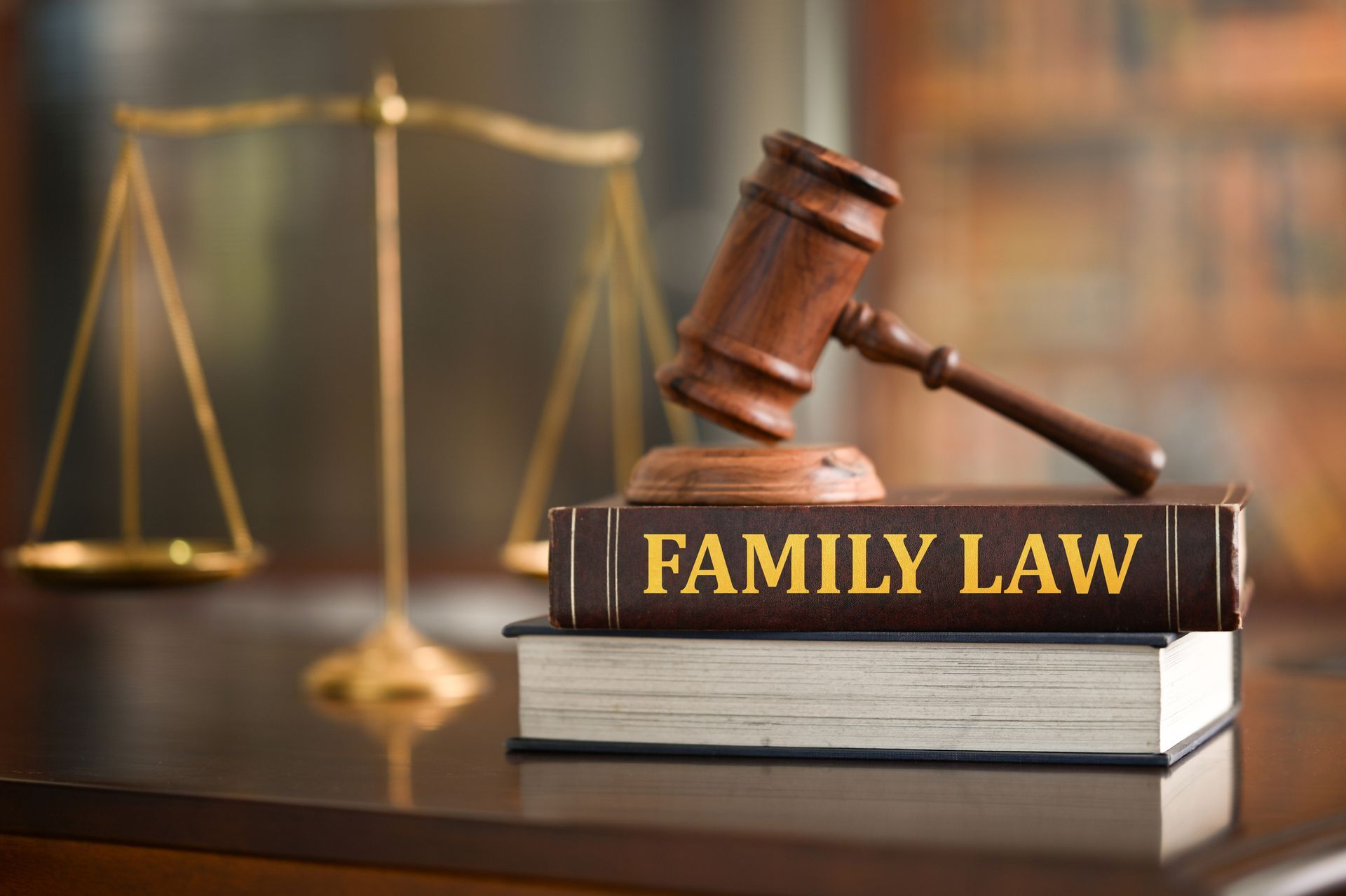 Family law texts organised on a polished wooden desk in a legal office.