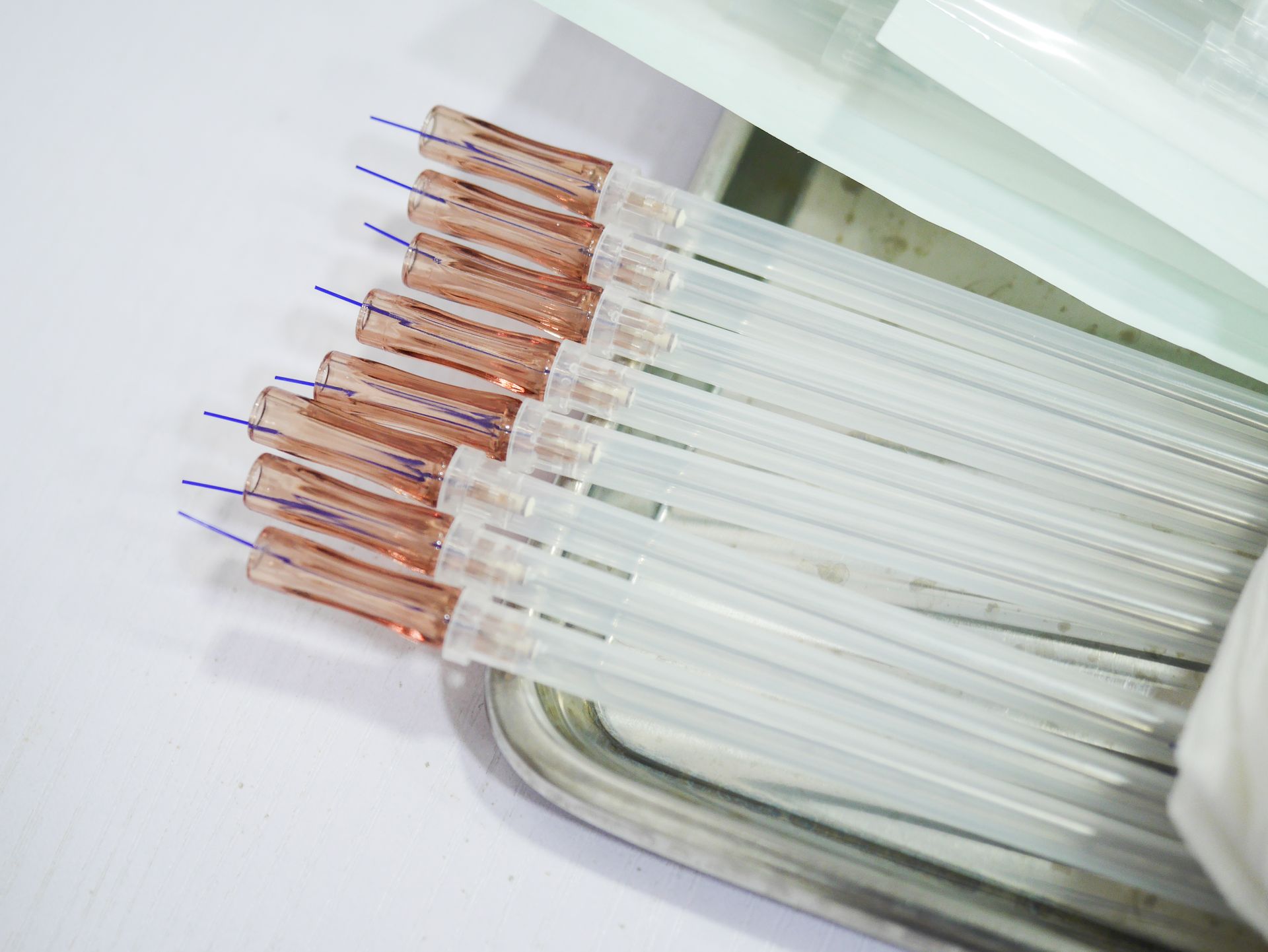 A bunch of needles are stacked on top of each other on a tray.