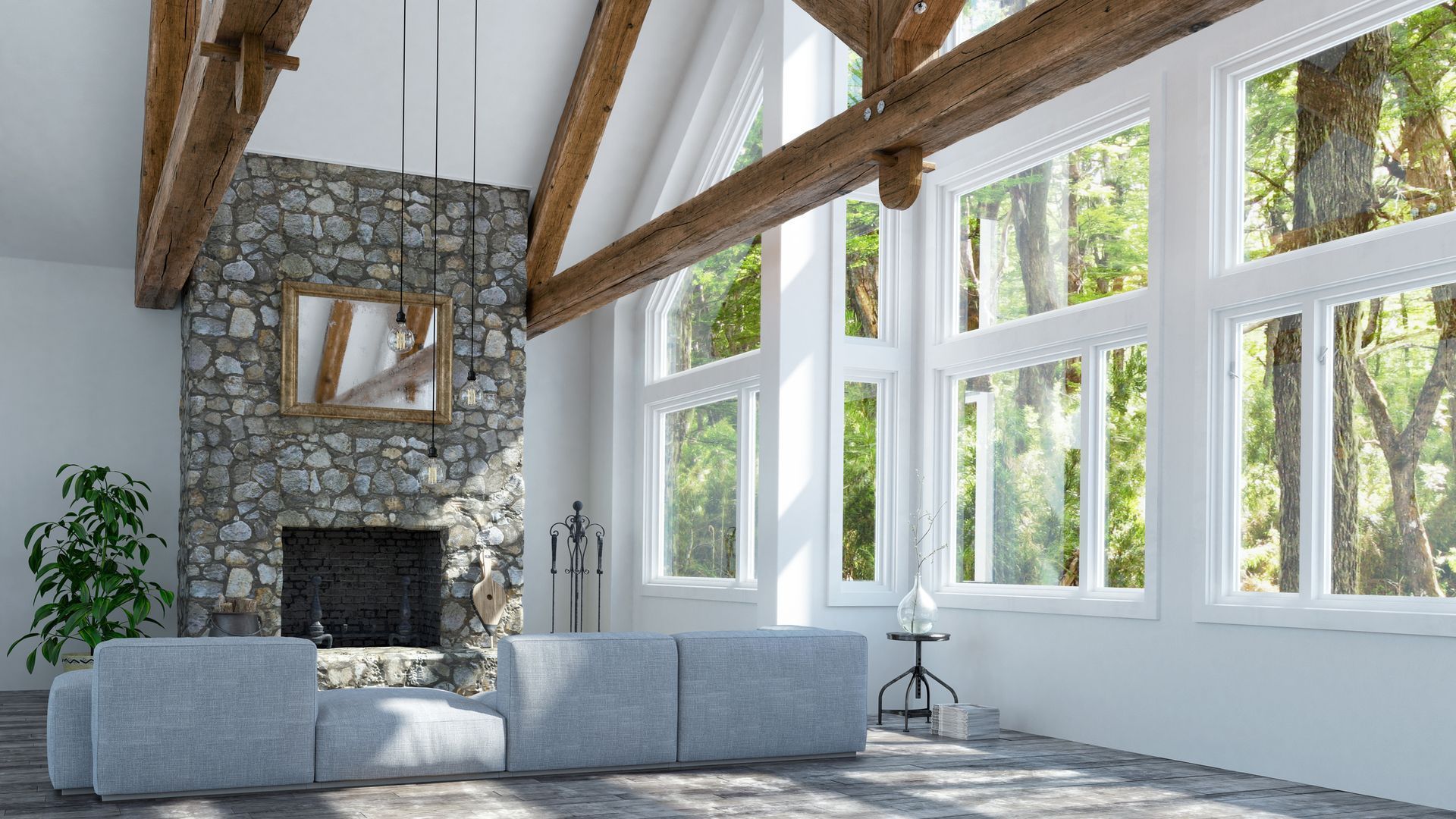 Living room with stone fireplace, large windows, wooden beams, and a gray sofa.
