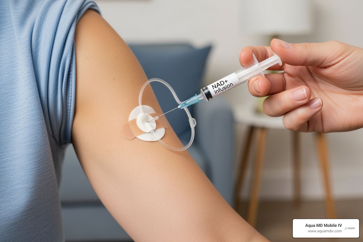 A person receiving an injection through an infusion set on their arm. A hand is holding the syringe.